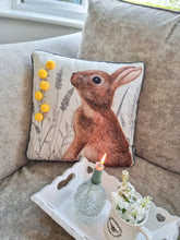 Load image into Gallery viewer, Meadow Hare Cushion WIth Yellow Pom Poms
